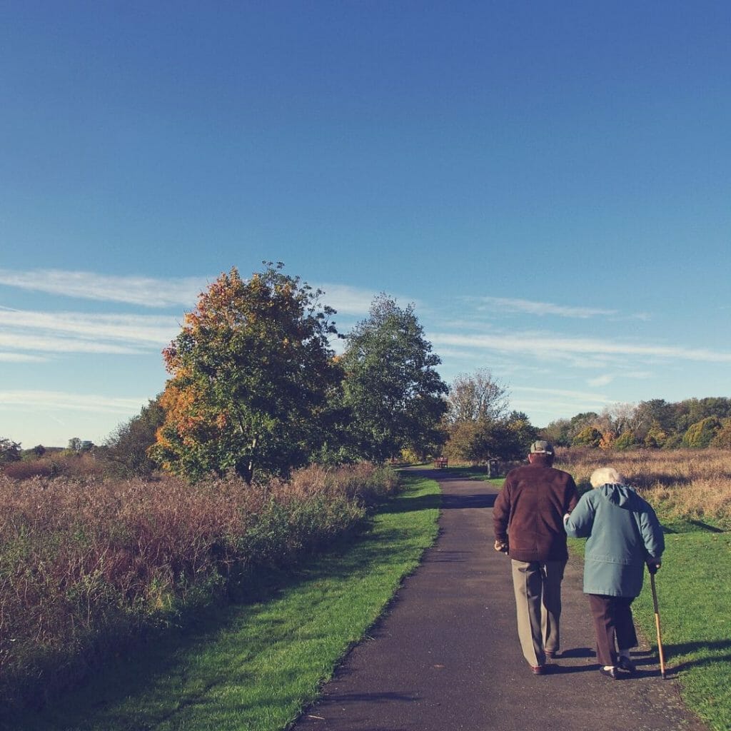 two retired people walking - money for retirement 