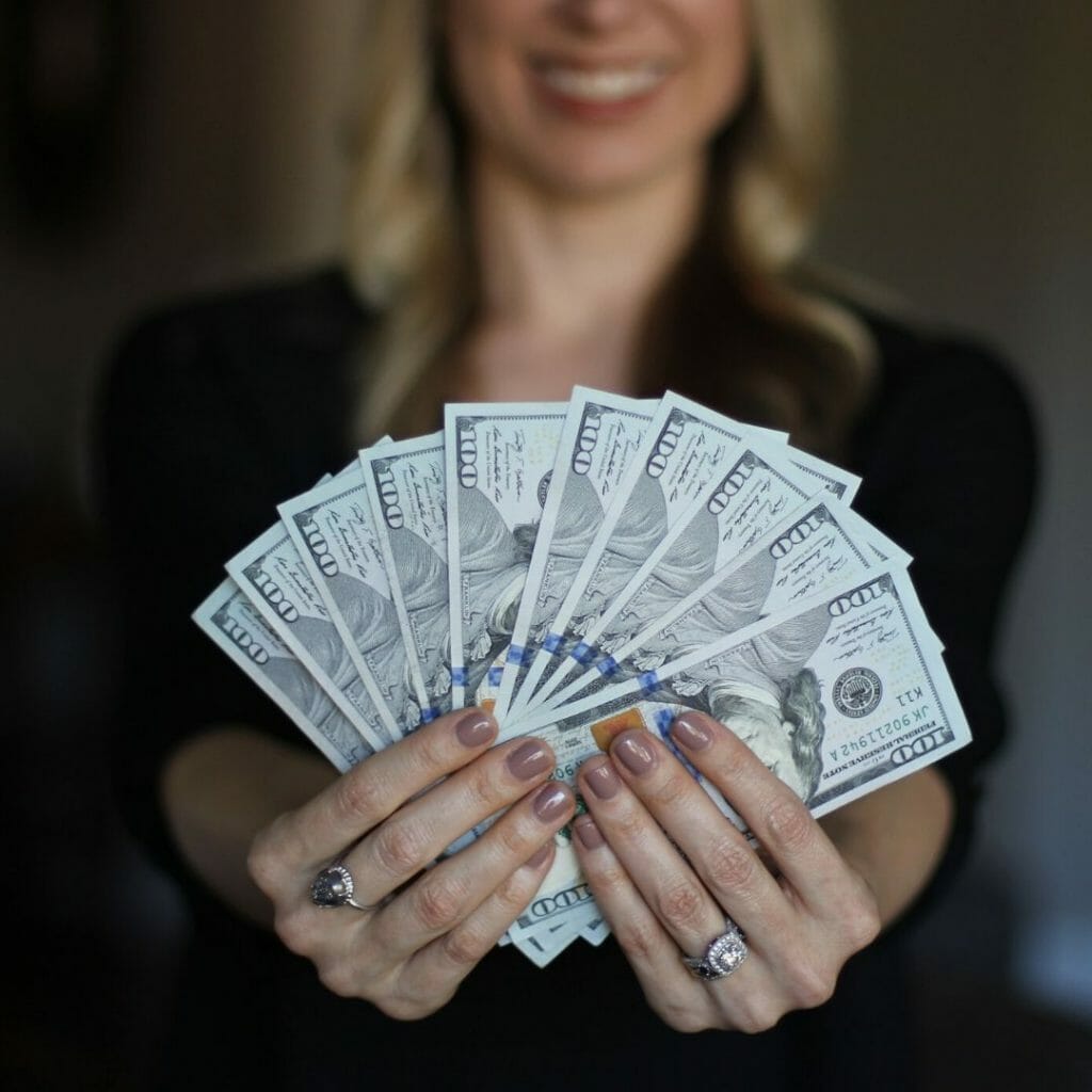 larger amount of money in womans hand